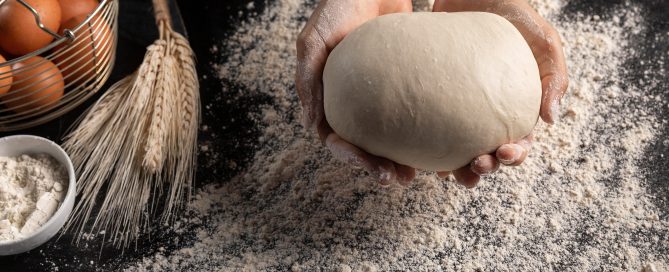 top view chef holding bread dough