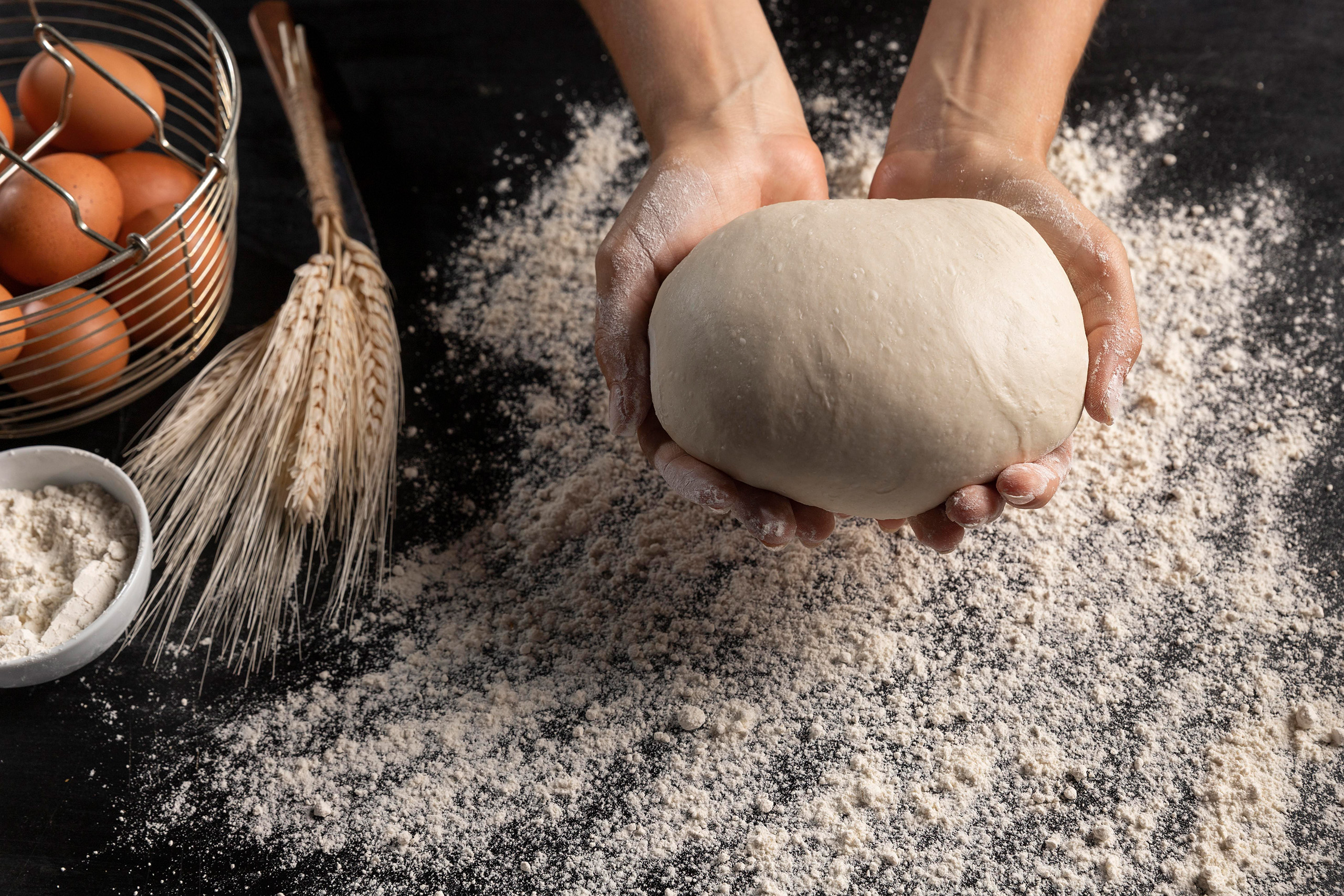 top view chef holding bread dough